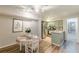 The dining area is equipped with modern lighting, a round table, and hardwood flooring at 215 Cobblestone Trl, Avondale Estates, GA 30002