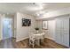 The dining area offers hardwood floors, decor, a modern chandelier, and an enclosed cabinet at 215 Cobblestone Trl, Avondale Estates, GA 30002