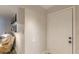 Neutral entryway featuring a white door and modern decor with a glimpse into a furnished living space at 215 Cobblestone Trl, Avondale Estates, GA 30002