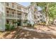 Apartment complex with multiple balconies, red shutters, and manicured landscaping at 215 Cobblestone Trl, Avondale Estates, GA 30002