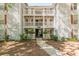 Apartment building exterior featuring multiple balconies, red shutters, and landscaped surroundings at 215 Cobblestone Trl, Avondale Estates, GA 30002