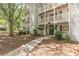 Condo exterior with balconies, red shutters, and a sidewalk leading to the entrance at 215 Cobblestone Trl, Avondale Estates, GA 30002
