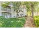 Exterior view of the apartment with a walkway and manicured landscaping at 215 Cobblestone Trl, Avondale Estates, GA 30002
