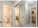 Hallway showing two bathrooms, hall closet, and view into living area at 215 Cobblestone Trl, Avondale Estates, GA 30002