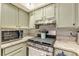Well-lit kitchen features stainless steel appliances, granite counters, and white subway tile backsplash at 215 Cobblestone Trl, Avondale Estates, GA 30002
