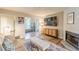 A stylish living room offers a fireplace, sleek console, and wood flooring at 215 Cobblestone Trl, Avondale Estates, GA 30002