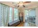 The sunroom is bright with natural light and features a ceiling fan and access to the balcony at 215 Cobblestone Trl, Avondale Estates, GA 30002