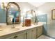 Traditional bathroom featuring double vanity with gold framed mirrors and blue tile walls at 3099 Farmington Se Dr, Atlanta, GA 30339
