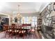 Formal dining room with stone fireplace, complemented by an ornate chandelier and classic wooden furniture at 3099 Farmington Se Dr, Atlanta, GA 30339