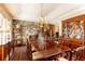 Spacious dining room featuring a stone accent wall, chandelier, and a large wooden table with seating for ten at 3099 Farmington Se Dr, Atlanta, GA 30339