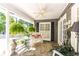 Inviting front porch featuring a bench, ferns, plants, and a ceiling fan for relaxing outdoors at 3099 Farmington Se Dr, Atlanta, GA 30339
