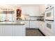 Bright kitchen featuring white cabinets, granite countertops, modern appliances, and an adjacent breakfast nook at 3099 Farmington Se Dr, Atlanta, GA 30339