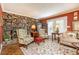 Charming living room with a stone fireplace, hardwood floors, and lots of natural light at 3099 Farmington Se Dr, Atlanta, GA 30339
