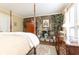 Another view of the main bedroom showcasing the stone fireplace, wooden floors, and natural light at 3099 Farmington Se Dr, Atlanta, GA 30339