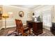 Bright home office with a dark wood desk, comfortable chairs, and French doors that let in plenty of natural light at 3099 Farmington Se Dr, Atlanta, GA 30339