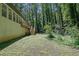 View of the backyard with a multi-level deck, brick exterior, and surrounding mature trees at 4066 Covered Bridge Sw Rd, Smyrna, GA 30082