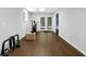 Finished basement featuring hardwood floors and fitness equipment, leading to a set of double doors at 4066 Covered Bridge Sw Rd, Smyrna, GA 30082