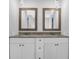 Modern bathroom with granite countertops, dual sinks, and stylish lighting fixtures at 4066 Covered Bridge Sw Rd, Smyrna, GA 30082