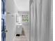 Bathroom featuring a sleek vanity, mirror, and a partial view of the shower with a white curtain at 4066 Covered Bridge Sw Rd, Smyrna, GA 30082
