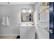 Bathroom with tiled walls, a vanity with a framed mirror, and a window letting in natural light at 4066 Covered Bridge Sw Rd, Smyrna, GA 30082