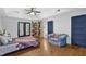 Spacious bedroom with hardwood floors, tray ceiling, and a cozy seating area at 4066 Covered Bridge Sw Rd, Smyrna, GA 30082