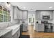 Modern kitchen with gray cabinets, granite countertops, stainless steel appliances, and a farmhouse sink at 4066 Covered Bridge Sw Rd, Smyrna, GA 30082
