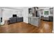 Open concept kitchen with stainless steel appliances, granite countertops, and gray cabinetry adjacent to living room at 4066 Covered Bridge Sw Rd, Smyrna, GA 30082
