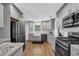 Well-appointed kitchen with gray cabinets, granite countertops, and stainless steel appliances at 4066 Covered Bridge Sw Rd, Smyrna, GA 30082