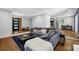 Spacious living room featuring modern flooring, a comfortable couch, and an open entrance to the kitchen at 4066 Covered Bridge Sw Rd, Smyrna, GA 30082