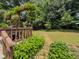 A beautifully landscaped backyard with a custom outdoor grilling area surrounded by lush greenery at 410 Hunters Cove Ct, Lawrenceville, GA 30044