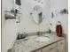 Modern bathroom vanity featuring granite countertop, decorative mirror, and updated fixtures at 410 Hunters Cove Ct, Lawrenceville, GA 30044