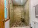 Tiled shower with glass door and bench seating in updated bathroom at 410 Hunters Cove Ct, Lawrenceville, GA 30044