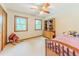 Bedroom with natural light, ceiling fan, and a wooden dresser at 410 Hunters Cove Ct, Lawrenceville, GA 30044