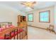 Cozy bedroom with two windows, ceiling fan, and a wooden dresser at 410 Hunters Cove Ct, Lawrenceville, GA 30044