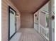Covered front porch featuring wood floors, painted siding, and a white front door with matching trim at 410 Hunters Cove Ct, Lawrenceville, GA 30044