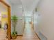 Light and airy hallway with wood floors and neutral-colored walls leading to various rooms in the home at 410 Hunters Cove Ct, Lawrenceville, GA 30044