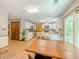 Open kitchen and dining area featuring white cabinets, stainless steel appliances, and access to the backyard at 410 Hunters Cove Ct, Lawrenceville, GA 30044