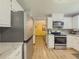 Spacious kitchen boasts stainless steel appliances, white cabinets, granite countertops, and open layout at 410 Hunters Cove Ct, Lawrenceville, GA 30044