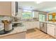 Well-equipped kitchen with white cabinets, granite countertops, stainless steel appliances, and tile backsplash at 410 Hunters Cove Ct, Lawrenceville, GA 30044