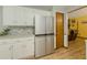 Bright kitchen featuring white cabinets, stainless steel refrigerator, granite countertops, and tile backsplash at 410 Hunters Cove Ct, Lawrenceville, GA 30044