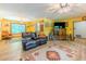 Comfortable living room featuring laminate floors, two leather couches, and a large entertainment center at 410 Hunters Cove Ct, Lawrenceville, GA 30044