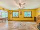 Yellow living room with large windows, and wood flooring, seamlessly connecting the kitchen and dining areas at 410 Hunters Cove Ct, Lawrenceville, GA 30044