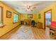 Bright yellow room with a ceiling fan, desk, and large windows overlooking the yard at 410 Hunters Cove Ct, Lawrenceville, GA 30044