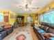 Spacious living room with wood-look floors, two leather couches, and large windows, creating a cozy atmosphere at 410 Hunters Cove Ct, Lawrenceville, GA 30044