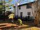 Back exterior of home, featuring a wooden deck with black railings and wooded backdrop at 4756 Manly Ct, Stone Mountain, GA 30088