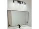 Bathroom vanity with a large modern mirror and new lighting at 4756 Manly Ct, Stone Mountain, GA 30088
