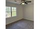 Bedroom featuring neutral walls, carpet, ceiling fan and two windows at 4756 Manly Ct, Stone Mountain, GA 30088
