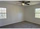 Bedroom featuring neutral walls, carpet, ceiling fan and two windows at 4756 Manly Ct, Stone Mountain, GA 30088