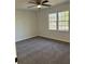 Bedroom featuring neutral walls, carpet, ceiling fan and two windows at 4756 Manly Ct, Stone Mountain, GA 30088