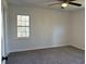 Bedroom featuring neutral walls, carpet, ceiling fan and a window at 4756 Manly Ct, Stone Mountain, GA 30088